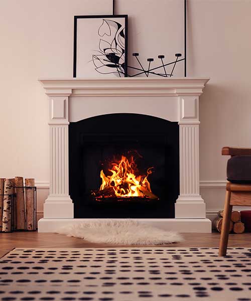 Modern fireplace with burning wood in room