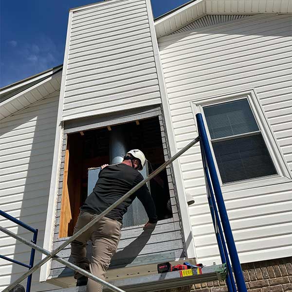Technician Installing Factory Built Fireplace