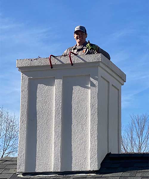 Technician working on Chimney Technician working on Chimney